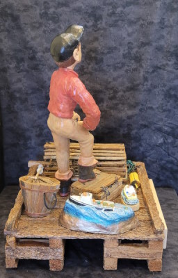 a Cape Island fisherman on a wharf with small Cape Island boats