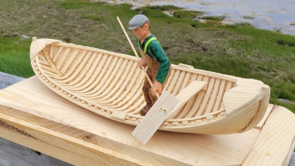 A fisherman is harvesting seaweed in his skiff.