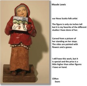 a small portrait carving of Maude Lewis, she holds a painting