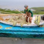 Carving of a fisherman harvesting seaweed